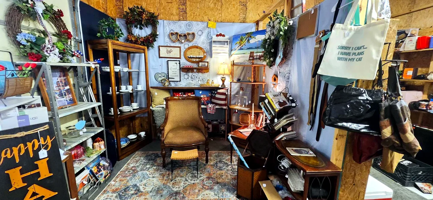 Curated booth with furniture and books